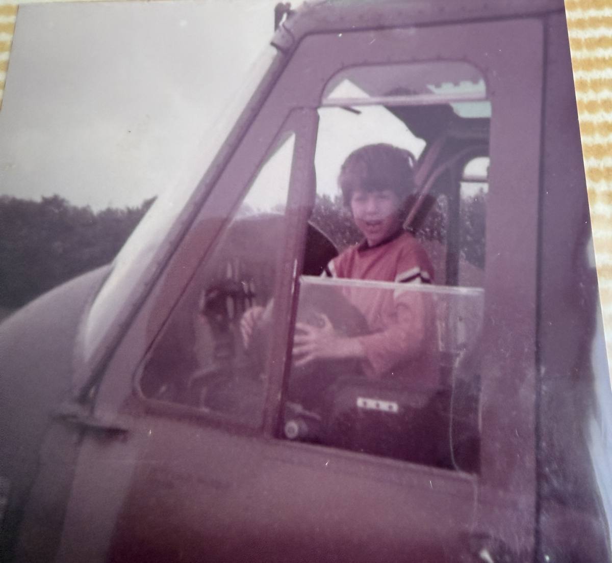 Robert as a boy in the pilot seat of an Army helicopter in Germany